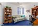 Bedroom or office featuring a futon, bookshelf with plants and decorations, and a desk for work at 6520 E Hacienda La Noria Ln, Gold Canyon, AZ 85118