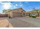 Single-story home features a two-car garage, rock landscaping, and desert plants in a well-maintained front yard at 6520 E Hacienda La Noria Ln, Gold Canyon, AZ 85118