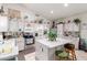 Charming kitchen featuring white cabinetry, stainless steel appliances, and a functional center island at 6520 E Hacienda La Noria Ln, Gold Canyon, AZ 85118