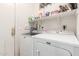 Laundry room with a washer and dryer, as well as shelving for detergent and cleaning supplies at 6520 E Hacienda La Noria Ln, Gold Canyon, AZ 85118