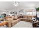 Spacious living room featuring tile floors, a large sectional sofa, and a ceiling fan for added comfort at 6520 E Hacienda La Noria Ln, Gold Canyon, AZ 85118