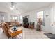 Bright living room featuring tile floors, a ceiling fan, a comfortable sofa, and natural light from large windows at 6520 E Hacienda La Noria Ln, Gold Canyon, AZ 85118