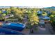 View of backyard with pool, turf, solar panels, and covered horse stalls at 6615 E Desert Cove Ave, Scottsdale, AZ 85254