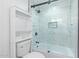 Updated bathroom with tiled walls, glass shower door, white cabinet and toilet at 6615 E Desert Cove Ave, Scottsdale, AZ 85254