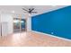 Bedroom with sliding glass door, blue wall, and light-colored flooring at 6615 E Desert Cove Ave, Scottsdale, AZ 85254
