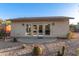 Backyard studio features stucco siding, a circular patio, and desert landscaping at 6615 E Desert Cove Ave, Scottsdale, AZ 85254