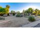 Well-maintained home with desert landscaping including yucca and cacti, plus mature trees at 6615 E Desert Cove Ave, Scottsdale, AZ 85254
