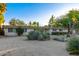 Well-maintained home with desert landscaping including yucca and cacti, plus mature trees at 6615 E Desert Cove Ave, Scottsdale, AZ 85254