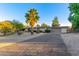 Charming home with a long driveway and mature landscaping featuring large palm trees at 6615 E Desert Cove Ave, Scottsdale, AZ 85254
