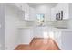 Bright kitchen with white cabinets, quartz countertops, stainless steel appliances, and warm-toned floor at 6615 E Desert Cove Ave, Scottsdale, AZ 85254