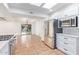 Spacious kitchen featuring stainless steel refrigerator, modern appliances, and beautiful tile flooring at 6615 E Desert Cove Ave, Scottsdale, AZ 85254