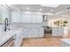 Bright and modern kitchen features white cabinetry, stainless steel appliances, and stylish countertops at 6615 E Desert Cove Ave, Scottsdale, AZ 85254