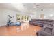 Open-concept living room with an exercise machine, a comfy gray sectional, and access to the backyard at 6615 E Desert Cove Ave, Scottsdale, AZ 85254