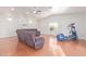 Spacious living room features gray sectional seating and an exercise machine, with plenty of natural light at 6615 E Desert Cove Ave, Scottsdale, AZ 85254