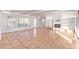 Bright living room with tile flooring, fireplace, and large windows at 6615 E Desert Cove Ave, Scottsdale, AZ 85254