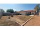 Expansive backyard ready for landscaping, featuring a block wall and sliding glass door access to the home at 6630 W Superior Ave, Phoenix, AZ 85043