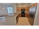 Efficient kitchen featuring stainless steel appliances and wood cabinets with breakfast bar area at 6820 S 68Th Ln, Laveen, AZ 85339