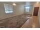 Spacious living room with tile entry and carpet floors; ready for your personal touch at 6820 S 68Th Ln, Laveen, AZ 85339