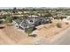 Aerial view of a new home under construction featuring a three car garage and tile roof at 8125 E Gail Rd, Scottsdale, AZ 85260