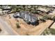 Aerial view of a new home under construction featuring a three car garage and tile roof at 8125 E Gail Rd, Scottsdale, AZ 85260