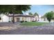 Expansive home exterior features a sprawling yard, covered patio, and a refreshing pool for outdoor enjoyment at 8125 E Gail Rd, Scottsdale, AZ 85260