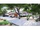 Charming single-story home with a three-car garage, stone accents, and a beautifully landscaped front yard at 8125 E Gail Rd, Scottsdale, AZ 85260