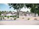 Charming single-story home with a stone facade, desert landscaping, and a welcoming arched entryway at 8125 E Gail Rd, Scottsdale, AZ 85260