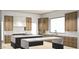 Modern kitchen design showcasing custom cabinetry, an island with seating, and stainless steel appliances at 8125 E Gail Rd, Scottsdale, AZ 85260