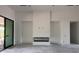 Bright living room with modern fireplace, floor to ceiling doors and view of the outdoor area at 8125 E Gail Rd, Scottsdale, AZ 85260
