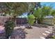 Gravel backyard featuring desert landscaping, a wooden fence, and mature trees that provide shade and privacy at 8637 E Solano Dr, Scottsdale, AZ 85250