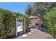 Private backyard retreat with pool access through an ivy-covered trellis, set among mature trees at 8637 E Solano Dr, Scottsdale, AZ 85250