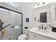 Bathroom featuring a shower with a black frame, toilet, and sink at 8637 E Solano Dr, Scottsdale, AZ 85250