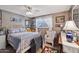 Comfortable bedroom with neutral tones, ceiling fan, and light-filled window at 8637 E Solano Dr, Scottsdale, AZ 85250