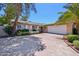 Charming single story home with a two car garage and shade trees in the front yard at 8637 E Solano Dr, Scottsdale, AZ 85250