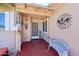 Inviting front porch with address numbers, decor, and a decorative metal bench at 8637 E Solano Dr, Scottsdale, AZ 85250
