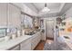 Kitchen with white cabinetry, stainless sink, and neutral countertops at 8637 E Solano Dr, Scottsdale, AZ 85250
