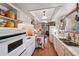 Bright kitchen featuring white cabinets, tile floors, and modern lighting at 8637 E Solano Dr, Scottsdale, AZ 85250