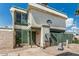 Charming two-story home with desert landscaping, green trim and neutral stucco exterior at 9050 N 51St Ln, Glendale, AZ 85302