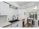 Modern kitchen showcasing white cabinets, stainless steel appliances, and stylish sink at 9050 N 51St Ln, Glendale, AZ 85302