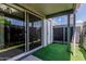 Cozy patio with sliding glass door access, artificial grass, and partial overhead cover at 9050 N 51St Ln, Glendale, AZ 85302
