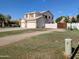 View of the side of the home showing a three car garage and partial driveway at 1015 S 132Nd St, Gilbert, AZ 85233