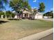 Charming two-story home with a well-maintained front yard and mature trees under a clear blue sky at 1015 S 132Nd St, Gilbert, AZ 85233