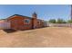 A view of the spacious backyard is showcased in this brick home with a chimney at 1028 W 5Th St, Mesa, AZ 85201