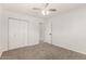 Bright bedroom with neutral carpet, white walls, and a ceiling fan at 1028 W 5Th St, Mesa, AZ 85201