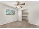 Cozy bedroom featuring a ceiling fan, window with blinds, and a walk-in closet at 1028 W 5Th St, Mesa, AZ 85201
