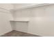 A clean and organized walk-in closet with shelves and carpeted flooring at 1028 W 5Th St, Mesa, AZ 85201