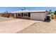 Exterior of a well-maintained home featuring brick accents and a white garage door at 1028 W 5Th St, Mesa, AZ 85201