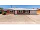 Charming brick home featuring a gravel front yard, white trim, and a single-car garage at 1028 W 5Th St, Mesa, AZ 85201