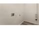 A bright laundry room shows the hookups on a blank, white wall and tiled floor at 1028 W 5Th St, Mesa, AZ 85201
