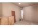 An unfinished utility room displays a water heater with a cement floor and cabinet at 1028 W 5Th St, Mesa, AZ 85201